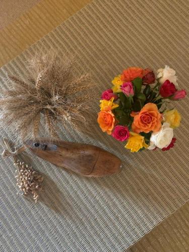 a bouquet of flowers on a table with a feather at Manoir de Malagorse in Cuzance