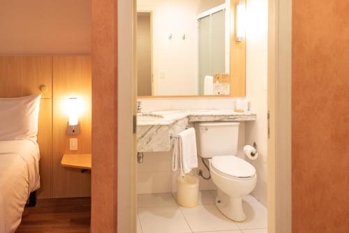 a small bathroom with a toilet and a sink at ibis Sao Paulo Barra Funda in Sao Paulo