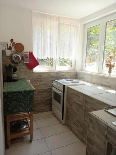 a kitchen with a stove and some windows at Beach Island House in Korčula