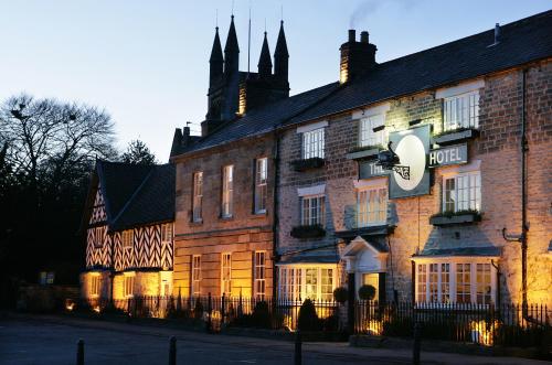a large brick building with a sign on it at The Black Swan - The Inn Collection Group in Helmsley