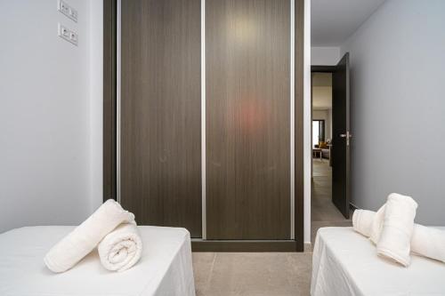 a bedroom with two beds with towels on them at Playa and Chill in San Juan de los Terreros
