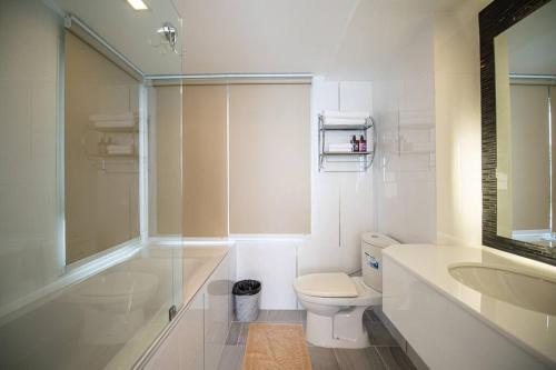 a white bathroom with a toilet and a sink at Sea View @The Ultimate River Beach @Rayong in Ban Nong Sanom