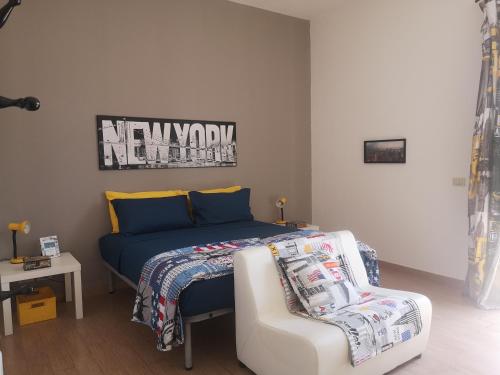 a bedroom with a bed and a couch and a chair at CASADEI24 in Guidonia