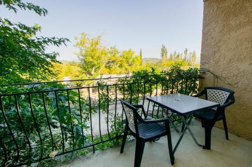 a table and two chairs sitting on a balcony at Hotel Carina in Apt