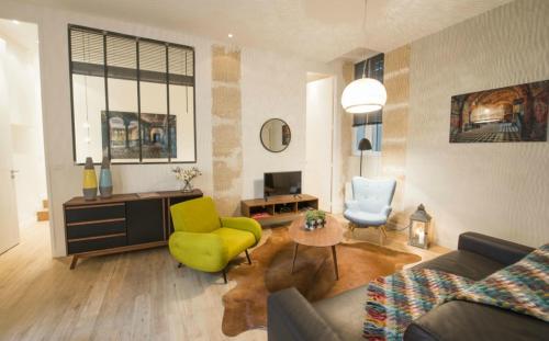 a living room with a couch and a yellow chair at Bulle in Paris