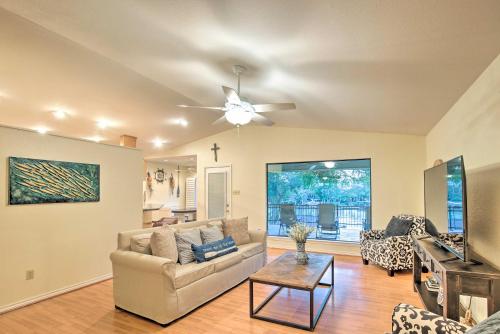 a living room with a couch and a ceiling fan at Lake Placid Home with Dock and Grill! in Seguin