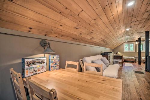 a dining room with a wooden ceiling and a table at Riverfront Tallulah Falls Cabin with Hot Tub! in Tallulah Falls