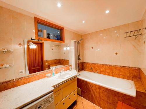 a bathroom with a tub and a sink and a bath tub at Terbatas Apartment in Rīga