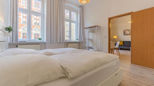 Säng eller sängar i ett rum på CityApartment - 53 m², 2 Zimmer, zentral, Netflix, Küche, Waschmaschine