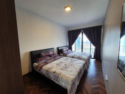 a bedroom with two beds and a large window at Landmark By Katana 3BR Glamorous Highrise Seaview Homestay Gurney无敌海景三房套房 in Tanjong Tokong