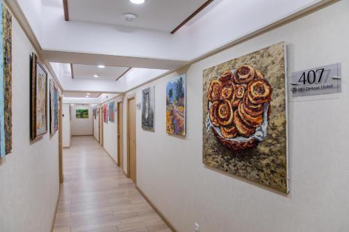 a hallway with many paintings on the walls at Art Deluxe Hotel in Tashkent