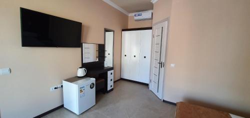 a room with a flat screen tv on a wall at SleepRestFly in Boryspilʼ