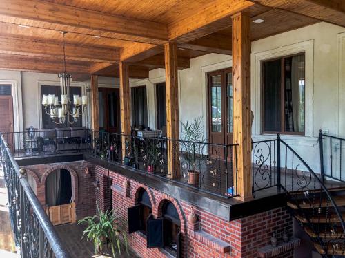 a porch of a house with a brick fireplace at Philia's Guest House in Sighnaghi