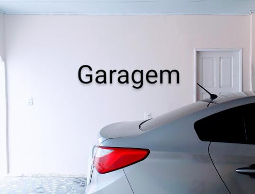 a white car parked in front of a white wall at RESIDENCIAL OLIVEIRA in Manaus