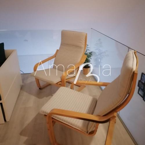 two chairs and a table in a room at AmaRiaCity AL in Aveiro