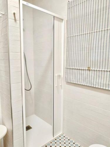 a shower with a glass door in a bathroom at Covas Beach Garden in Viveiro