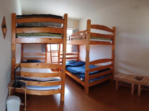 a room with three bunk beds in a room at ＬＯＤＧＥ ｎ"ｔｒｉｂｅ - Vacation STAY 79116v in Nichinan