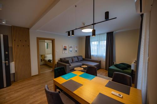 a living room with a table and a couch at Omega Apartments in Vrnjačka Banja