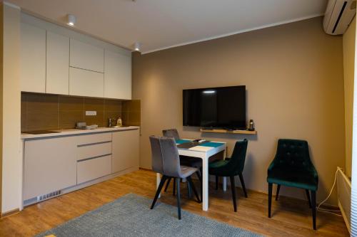 a kitchen and dining room with a table and chairs at Omega Apartments in Vrnjačka Banja