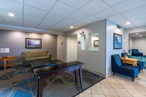 a waiting room with a table and a couch at Days Inn by Wyndham Greenville in Greenville