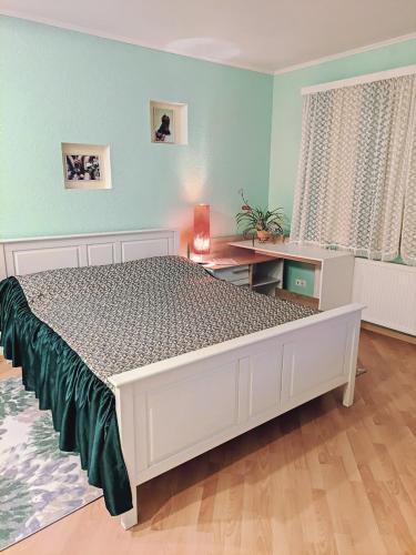 a bedroom with a large bed and a desk at Oasis Apartments in Pärnu