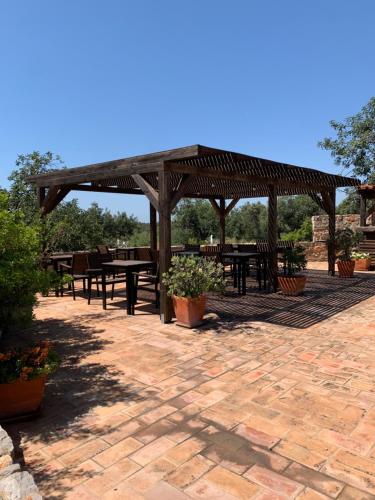 a picnic area with tables and a wooden pavilion at Casa Branca in Tavira