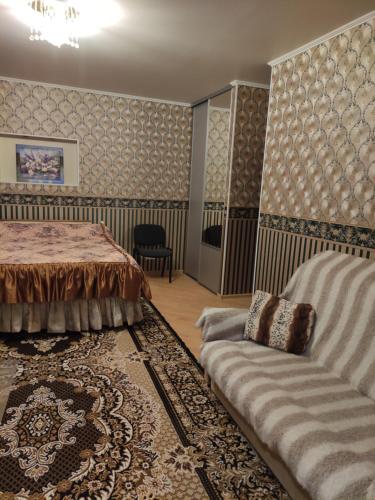 a living room with a bed and a couch at Oasis Apartments in Pärnu