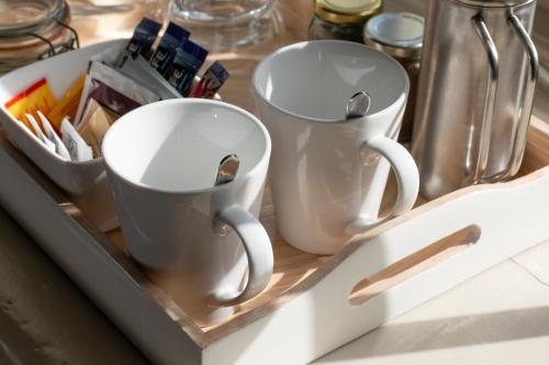 two coffee mugs in a tray on a counter at Castle Inn in Lydford