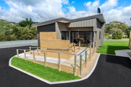 a rendering of a small house with a deck at Camp Waipu Cove in Waipu