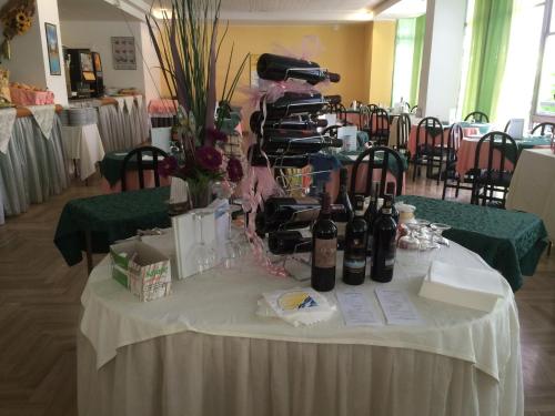 a table with bottles of wine on it at Hotel Sultano in Rimini