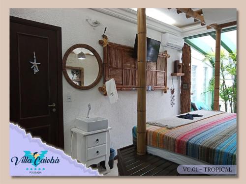 a bedroom with a bed and a sink and a mirror at Pousada Villa Caiobá in Matinhos