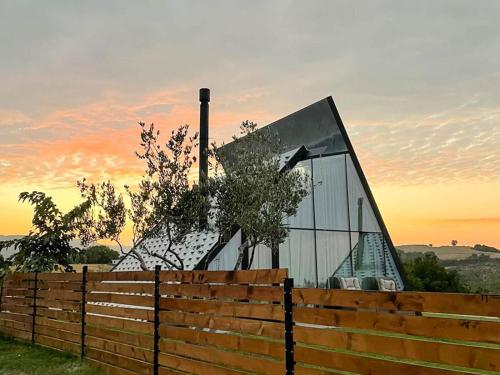 a building with a fence in front of it at 3 Hills Boutique - The Ranch Experience in Trílofos