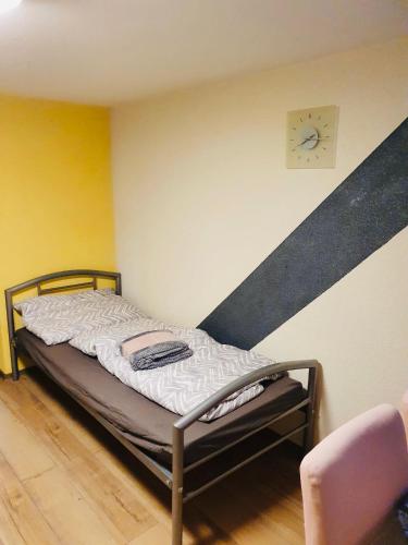 a small bed in a room with a staircase at VictoryForYou Unterkunft in Linz