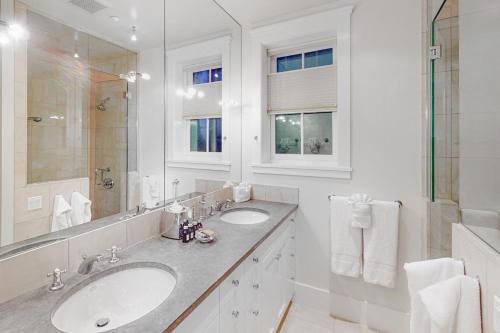 a white bathroom with two sinks and a mirror at Telluride Memories in Telluride