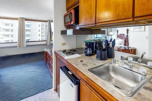a kitchen with a sink and a counter top at Marina Tower by TS in Honolulu