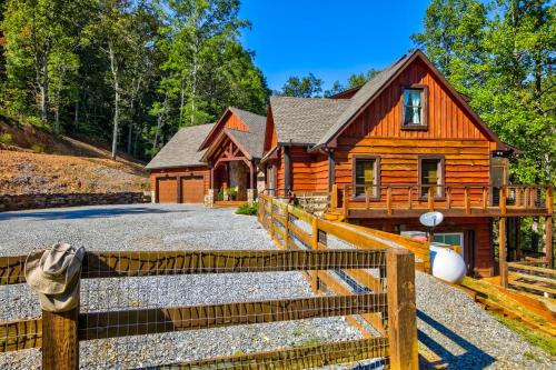 a log cabin with a fence in front of it at Talking Creek Lodge in Talking Rock