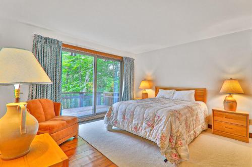a bedroom with a bed and a chair and a window at 1477 Salt Ash Road in Plymouth