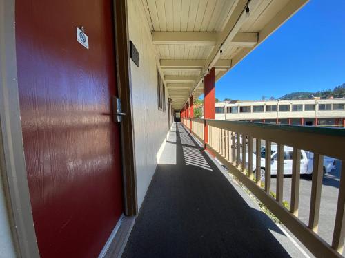 a hallway of a building with a red door at BeachCombers Inn in Gold Beach