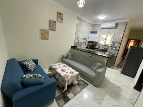 a living room with a couch and a table at Rayan Apartment in Hurghada