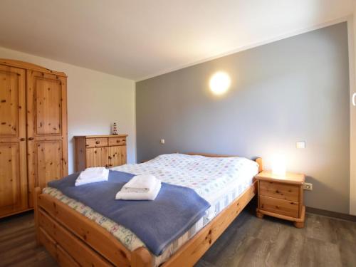 a bedroom with a bed with two towels on it at Ground-Floor Getaway with Garden in Insel Poel