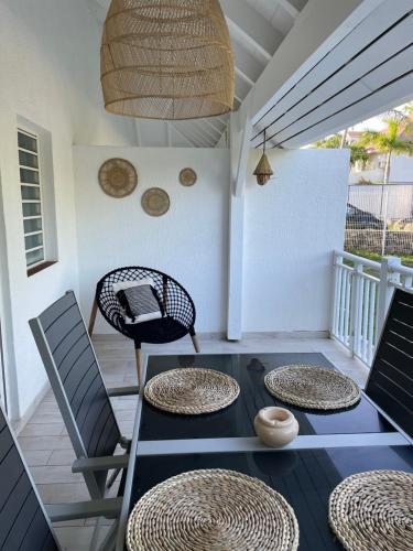 a patio with a table and chairs on a porch at Shamrock duplex in Saint Martin