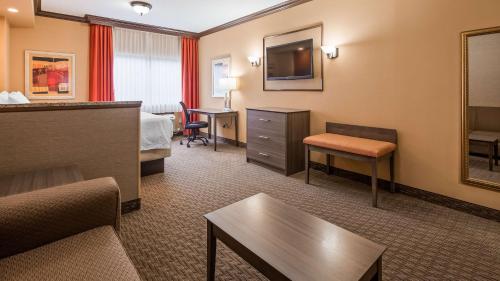 a hotel room with a bed and a tv at Best Western Plus North Canton Inn & Suites in North Canton