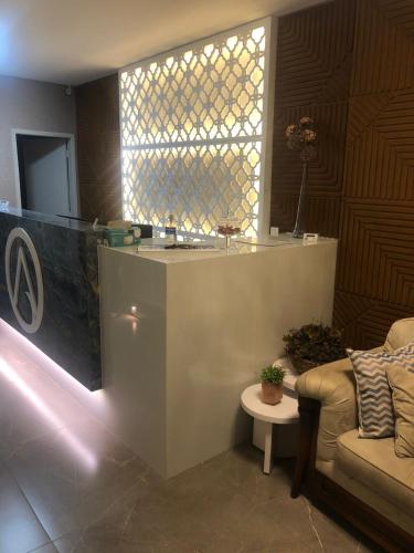a living room with a couch and a window at Antonio's Hotel e Spa - Airport in Brasilia