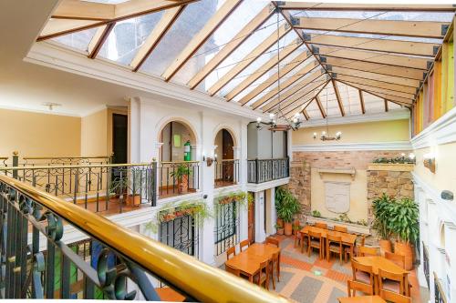 an indoorrium with tables and chairs in a building at Ayenda La Antigua in Tunja