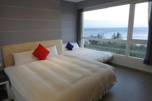 Postel nebo postele na pokoji v ubytování 南灣飯店 Kenting Nanwan Hotel