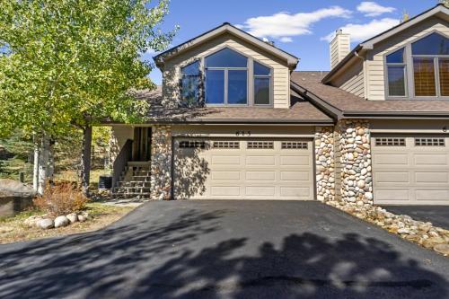 a house with a driveway with a garage at Gateway to the Wildside Townhouse in Estes Park