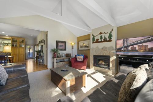 a living room with a couch and a fireplace at Gateway to the Wildside Townhouse in Estes Park