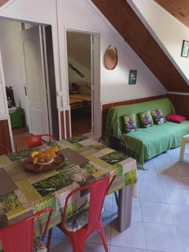 a living room with a table and a couch at Auberge du Cap in Cilaos