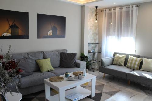 a living room with a couch and a table at Apartamento Vistas molineras in Consuegra