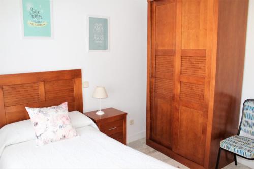 a bedroom with a bed and a chair at Apartamento Vistas molineras in Consuegra